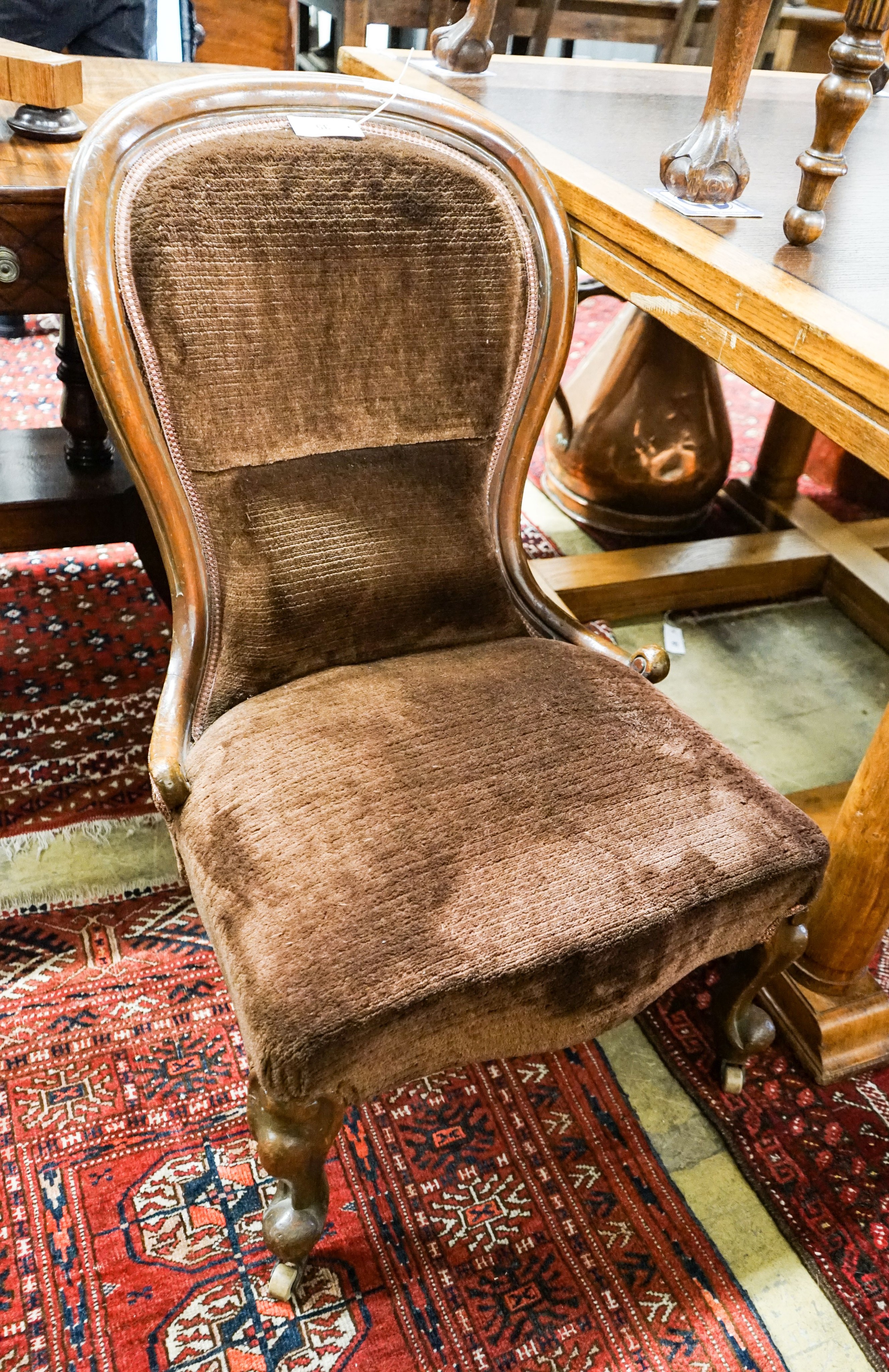 A Victorian mahogany spoonback nursing chair